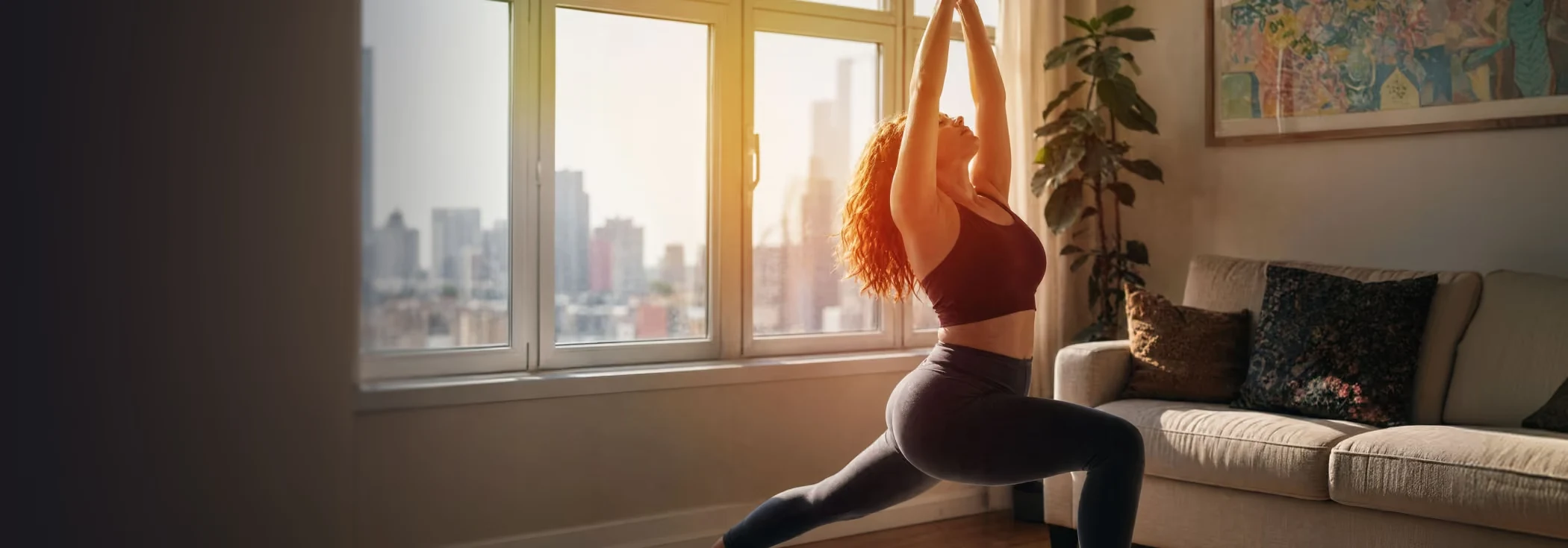 A woman stretching at home in the morning light